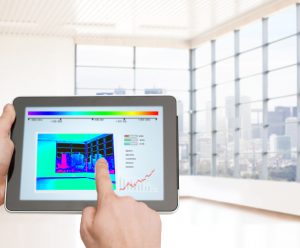 home, housing, people and technology concept - close up of man hands pointing finger to tablet pc computer and regulating room temperature over empty flat background